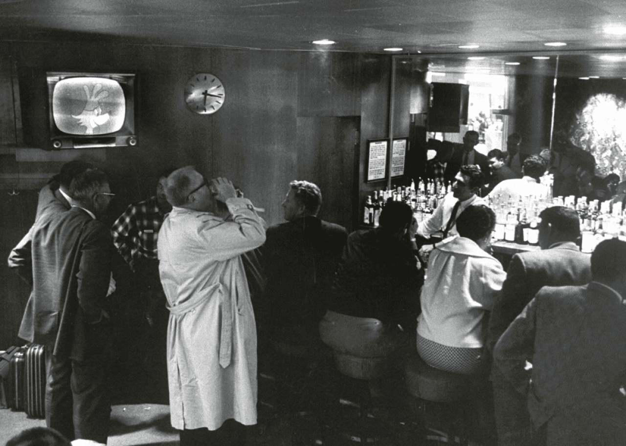 Customers chatting and drinking at a bar.